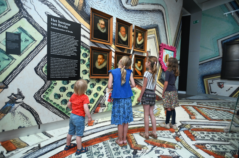 Kinderen bekijken portretten van het zeventiende eeuwse stadsbestuur in Breda in de tentoonstelling Nassau Familiespoor in het stedelijk museum Breda